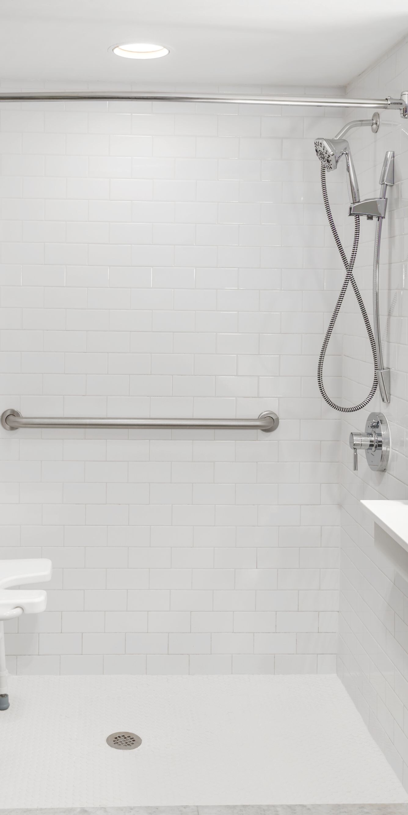 Roll-in shower with safety bars