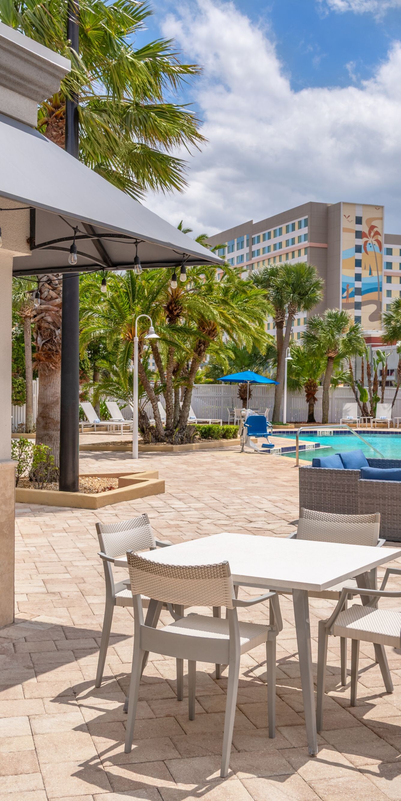 Outdoor patio with tables near pool