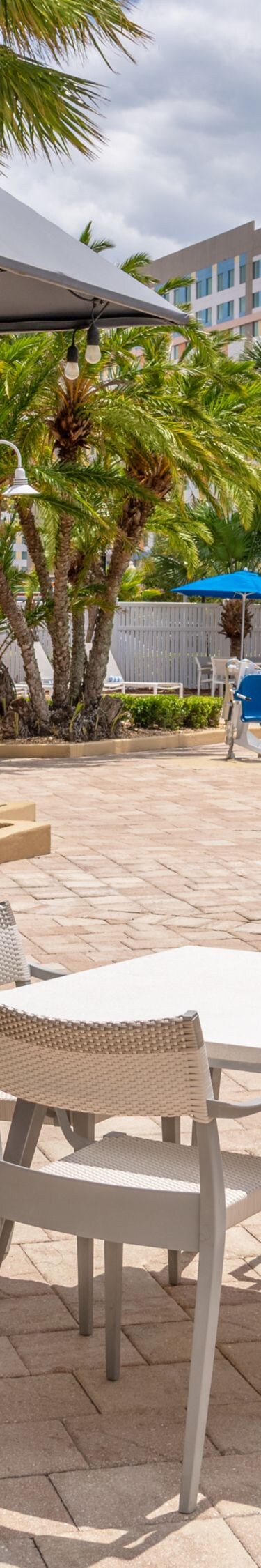 Outdoor patio with tables near pool