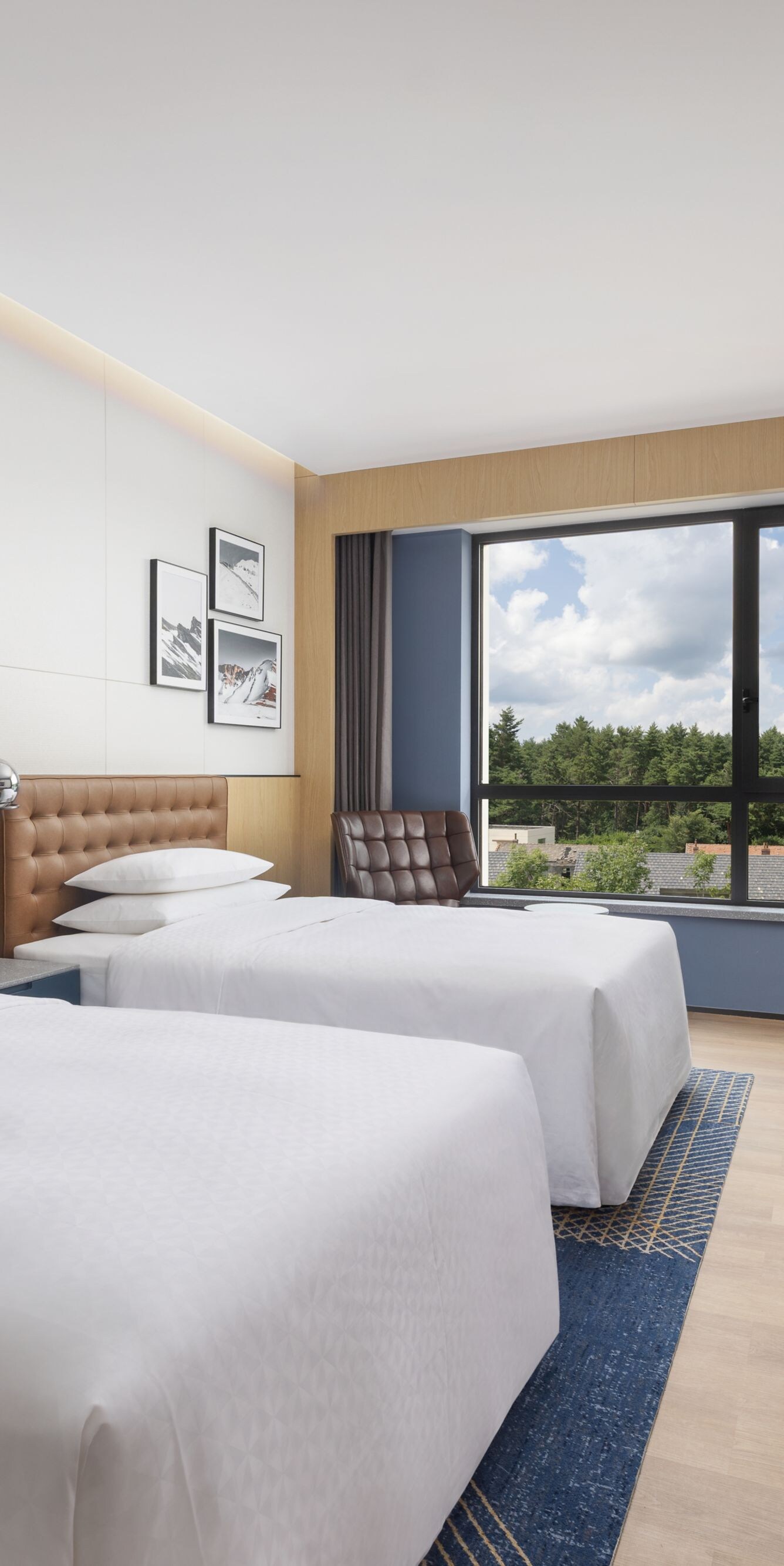 Two queen beds with modern design and view