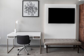 A modern desk and television in all guest rooms