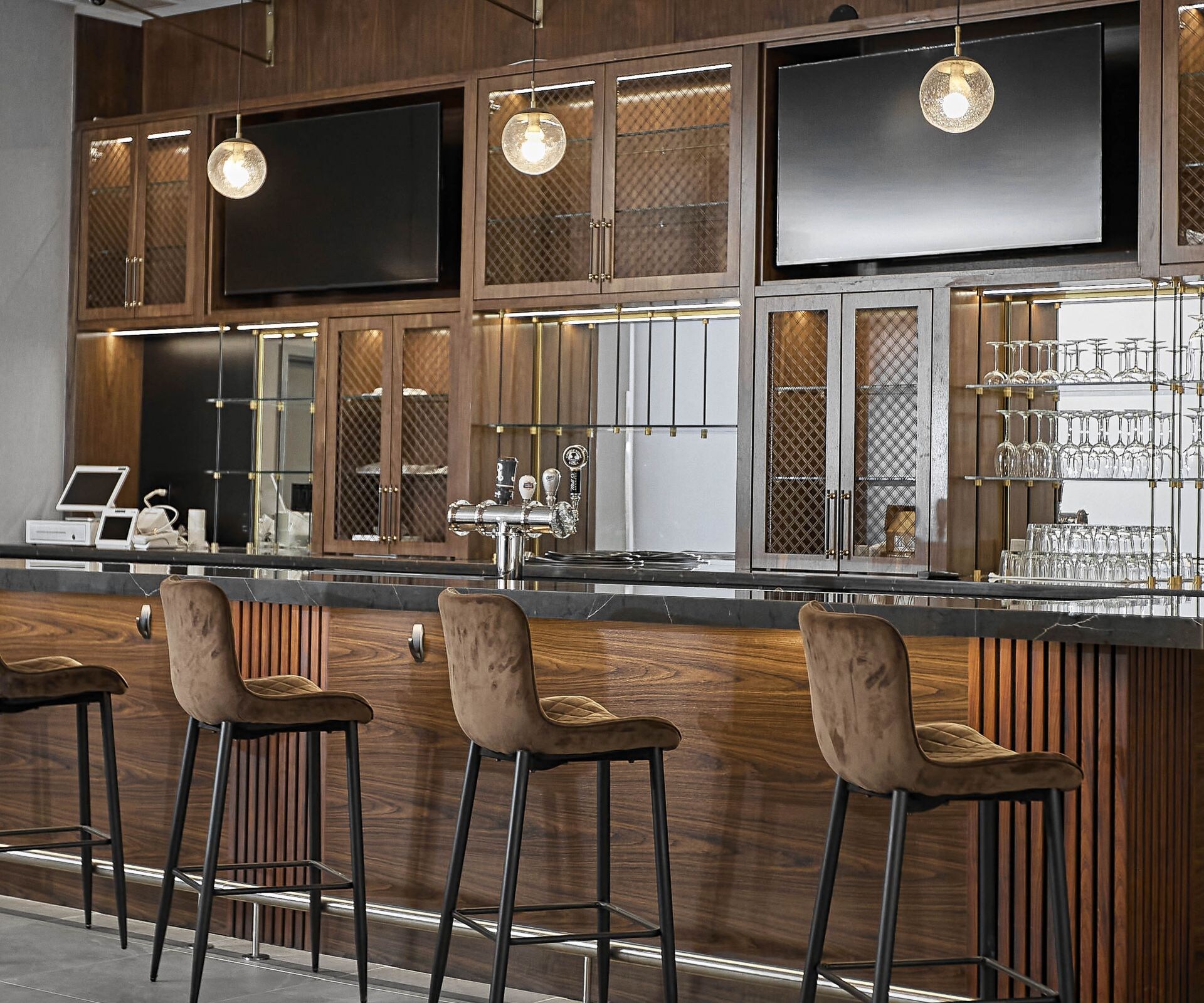 Bar has TVs, bar stools & showcases beer on tap.