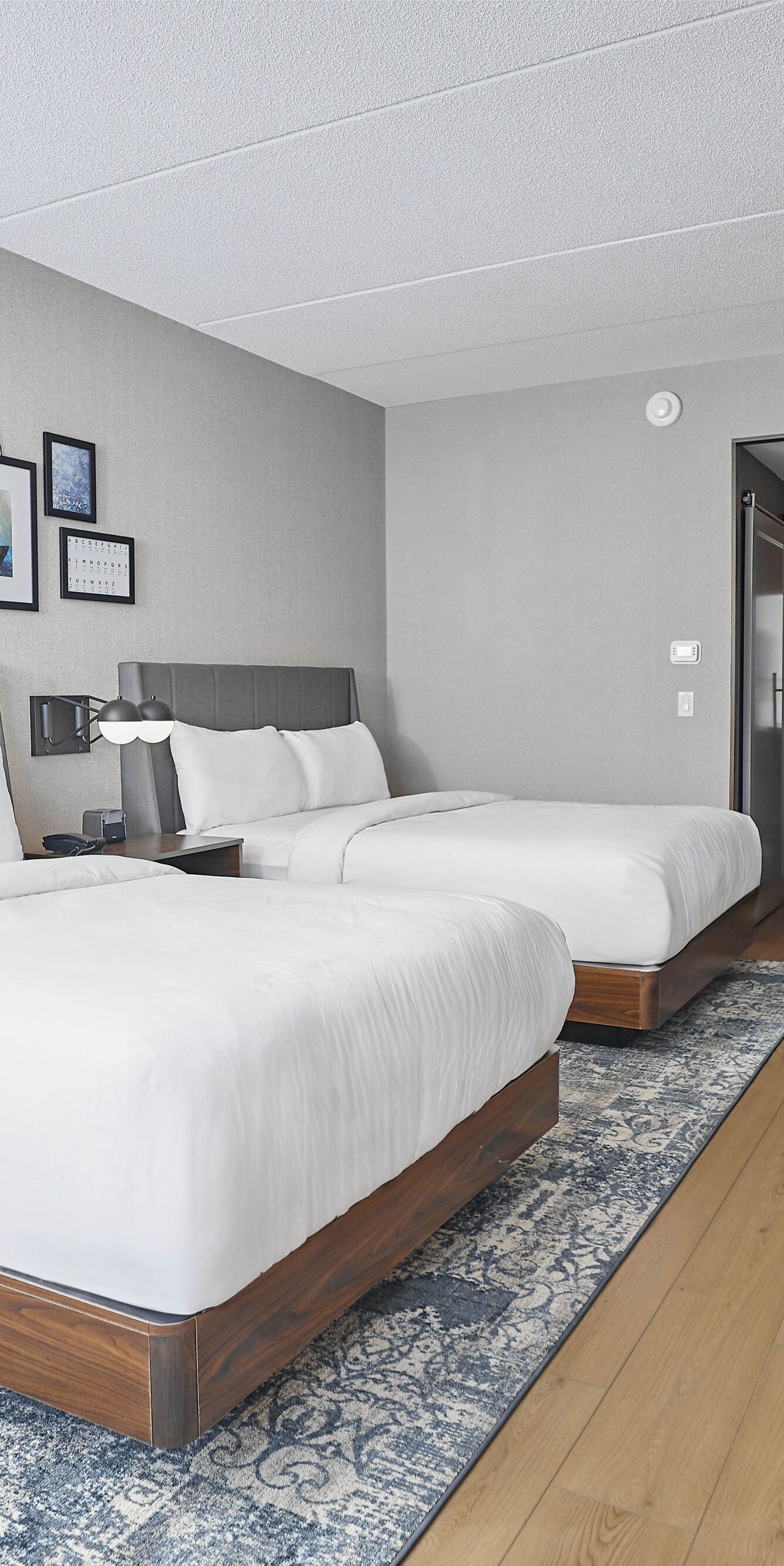Two queen beds, work station, TV and amenities.