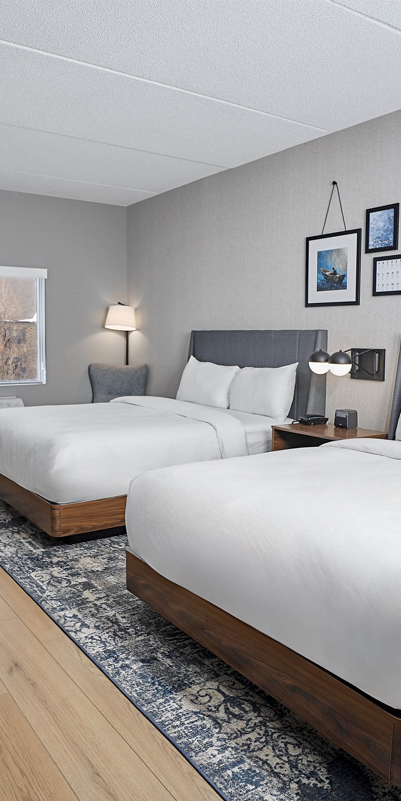 Two queen beds, work station, TV and city view.