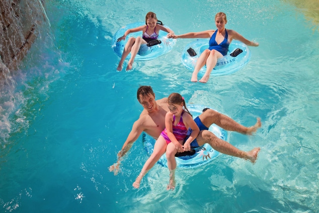 Family floating down a lazy river at the Paradise Spring water park