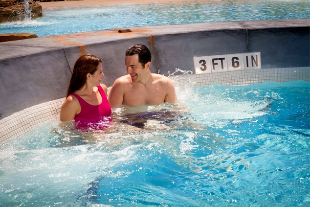 Couple sitting in a pool at the paradise Spring family fun water park