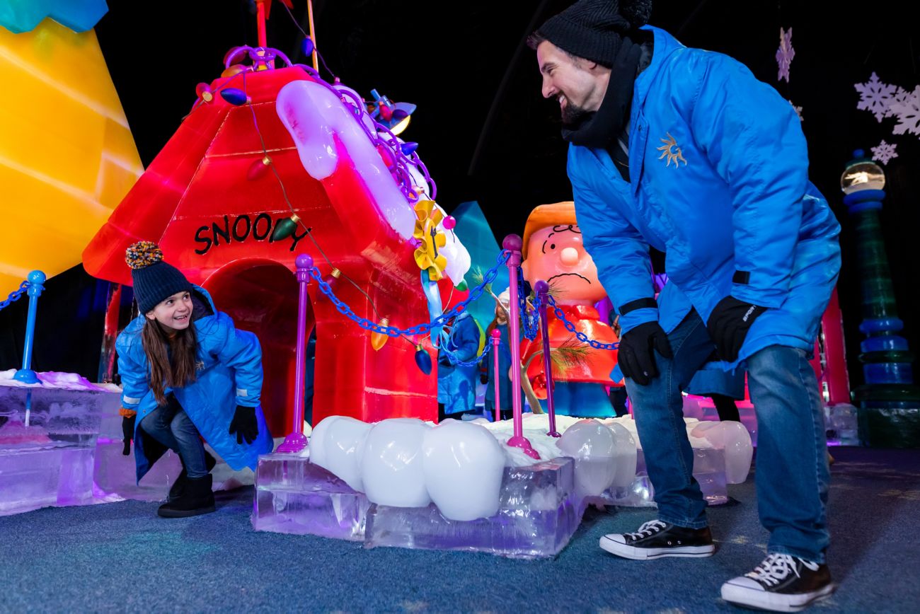 A child walking through an ice carving.