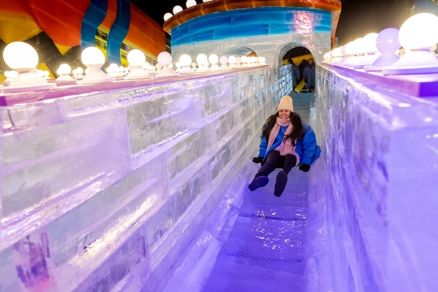 Child sliding down an ice slide.