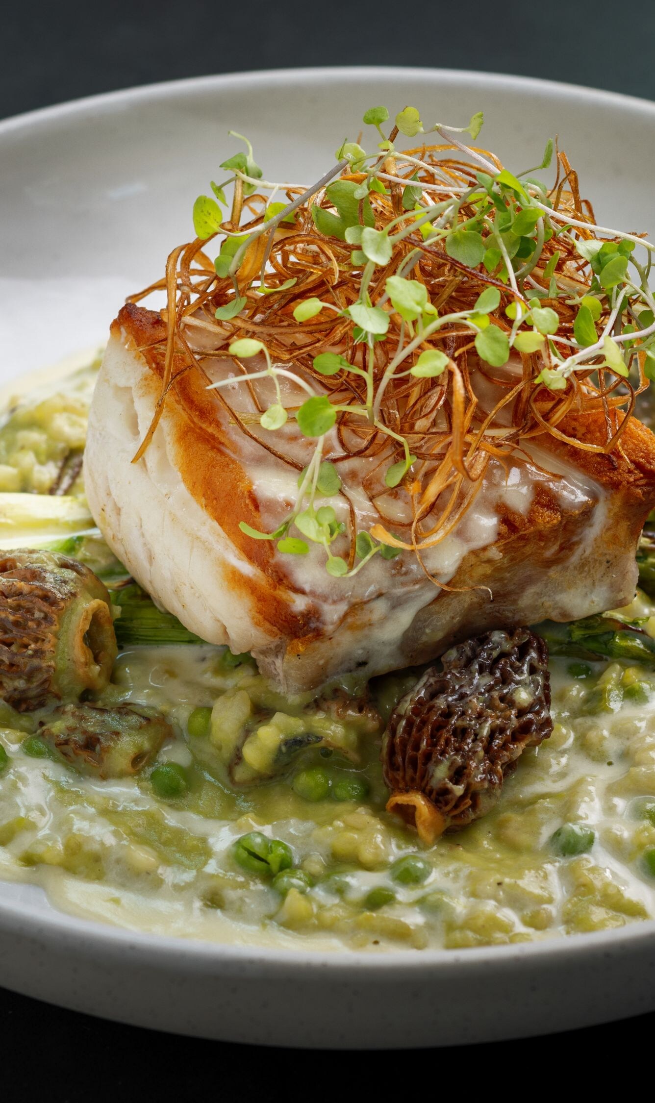 Grouper in pea risotto with water glass