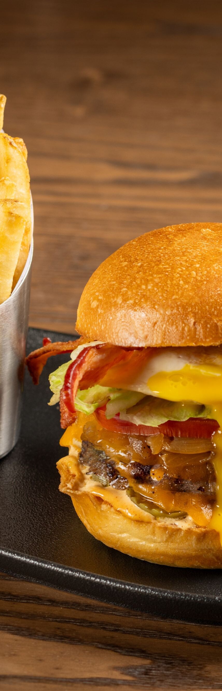 Burger, fries, and beer glass and can 