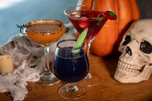 Colorful cocktails with Halloween props.
