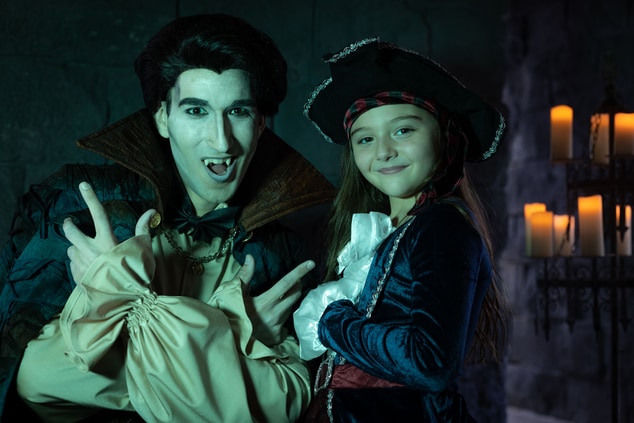 Actor and girl posing for a photo in costume.
