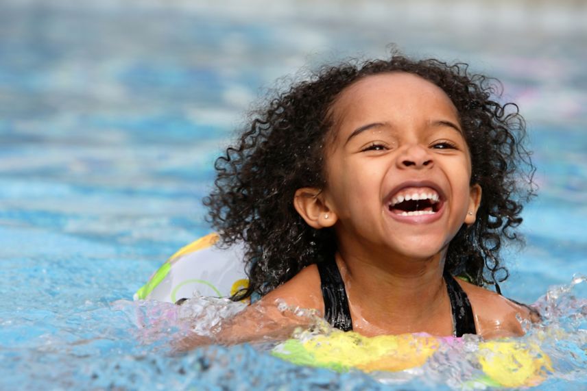 African American Girl in Pool on Yellow Float Laug