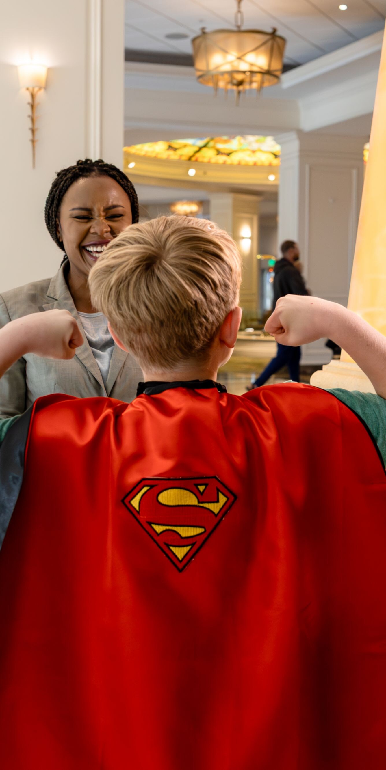 Child dressed as superhero in hotel lobby