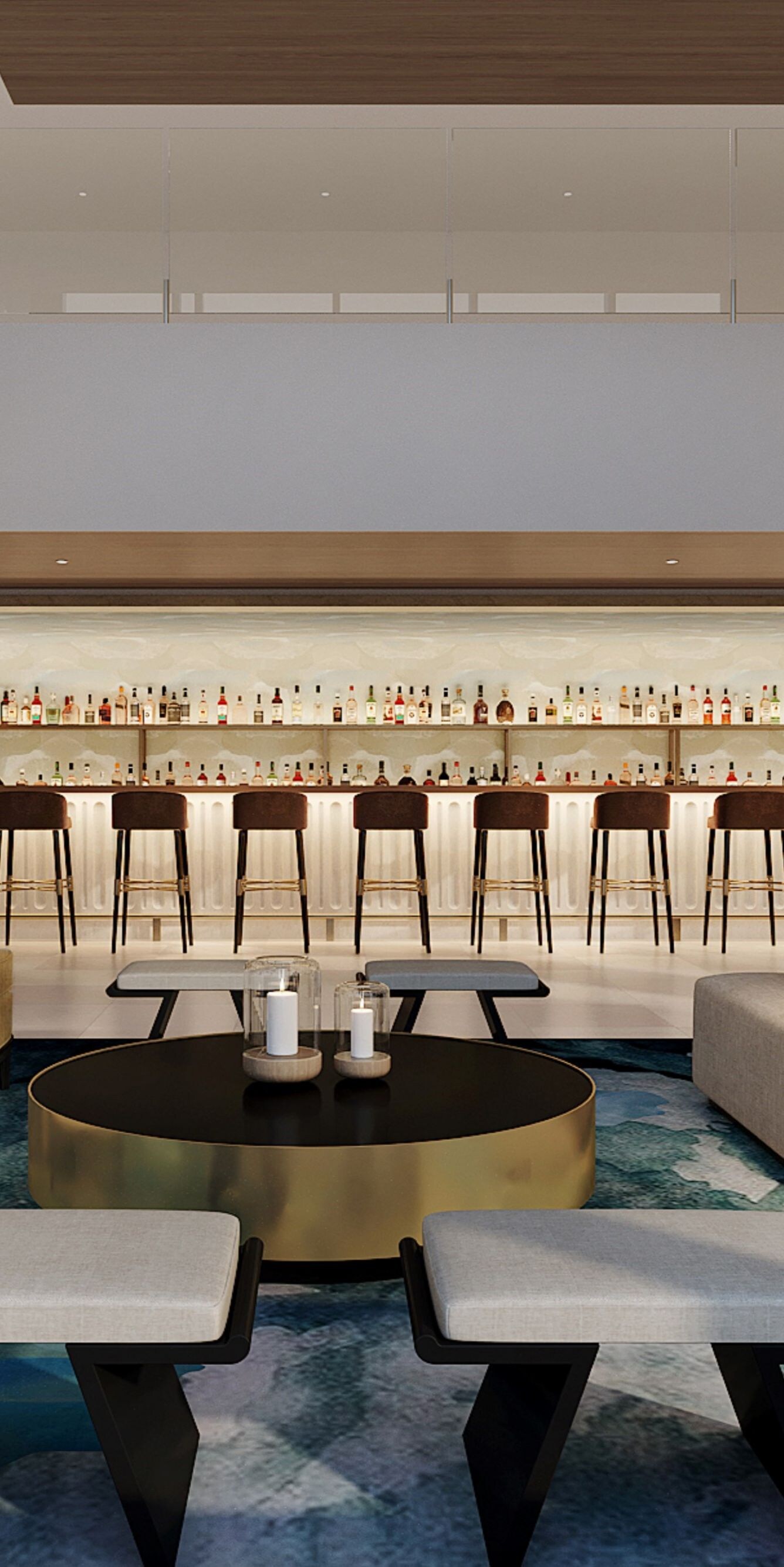 Bar with barstools, and sofas, tables and chairs.