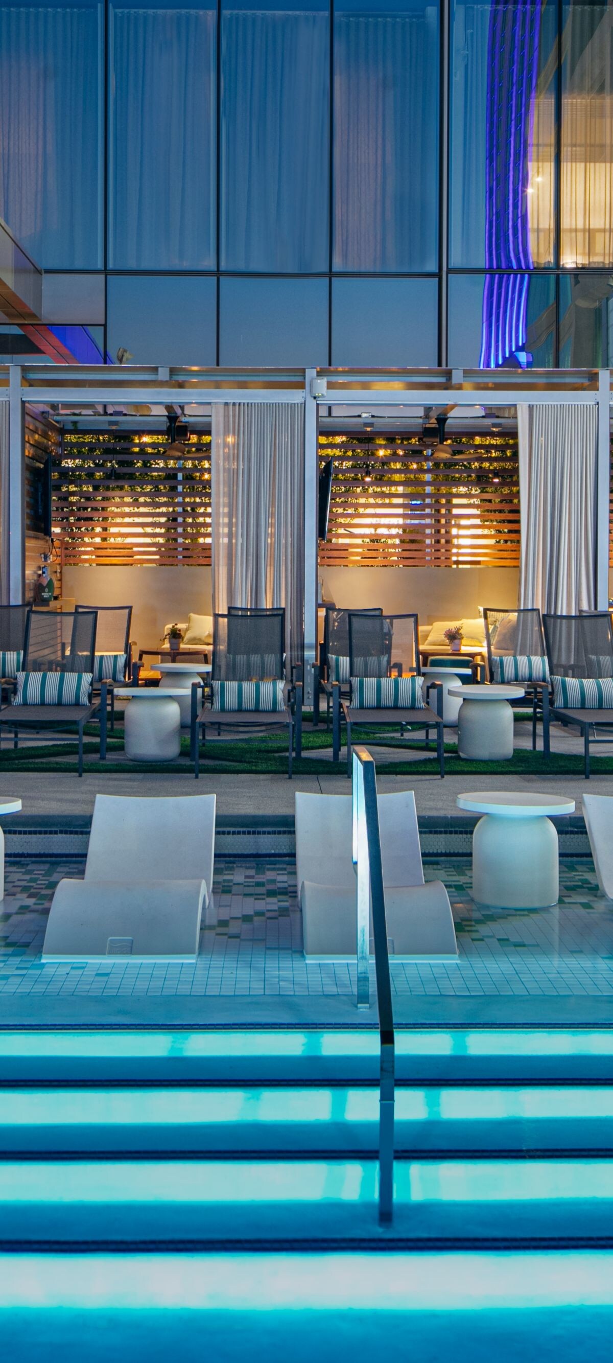 Aura Rooftop swimming pool with in-water loungers and private cabanas at JW Marriott Charlotte