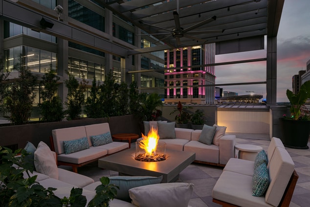 Aura Rooftop Bar firepit with lounge furniture