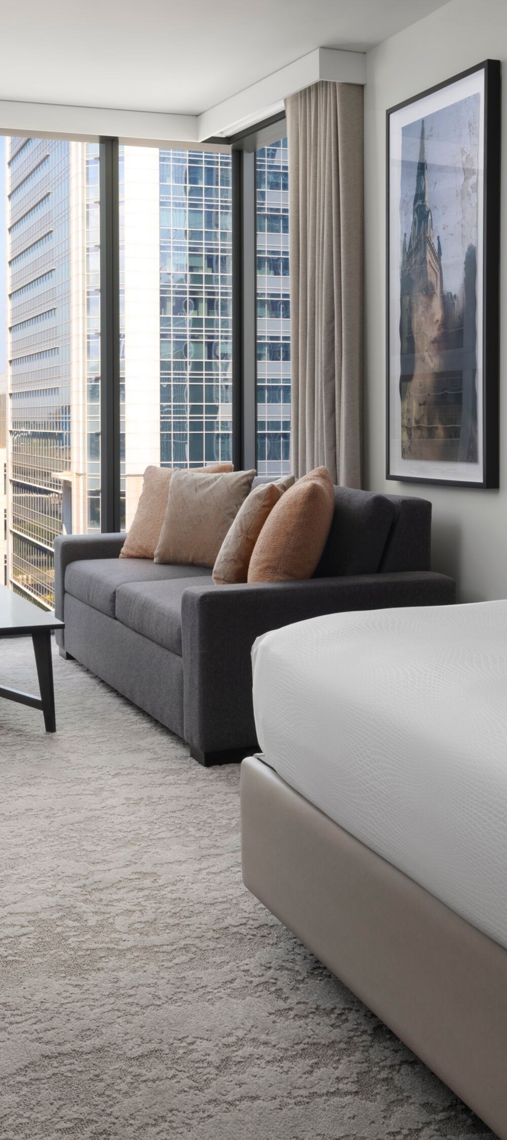 Luxury king guest room at JW Marriott Charlotte with floor-to-ceiling windows and city views
