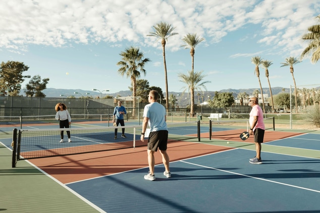 Group of people playing a game of pickleball