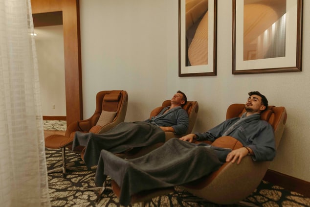 Two men in recliners reclining at a spa