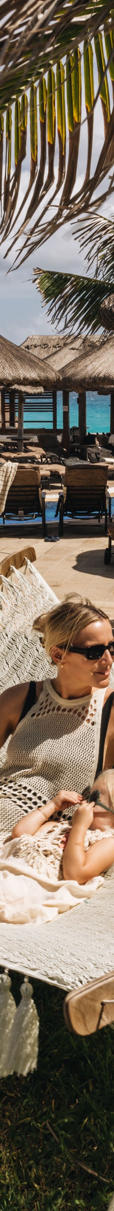 Guest relaxing in a hammock by the beach