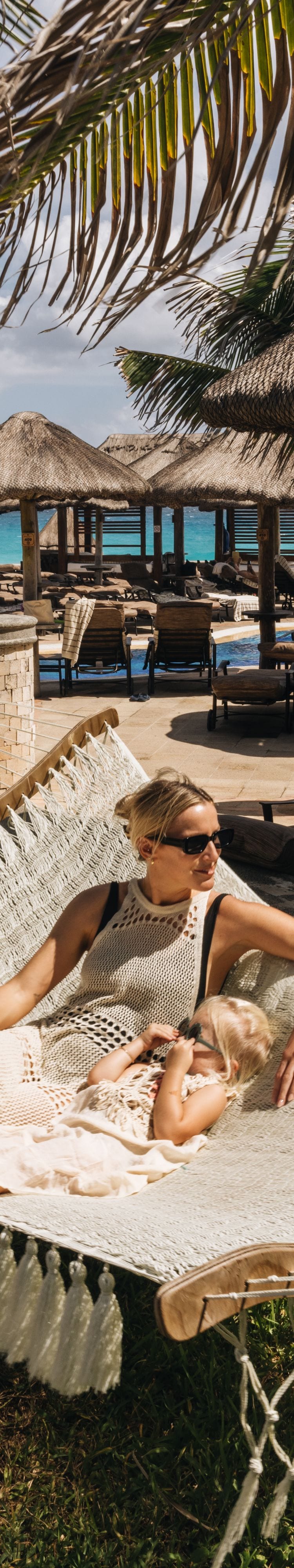 Guest relaxing in a hammock by the beach