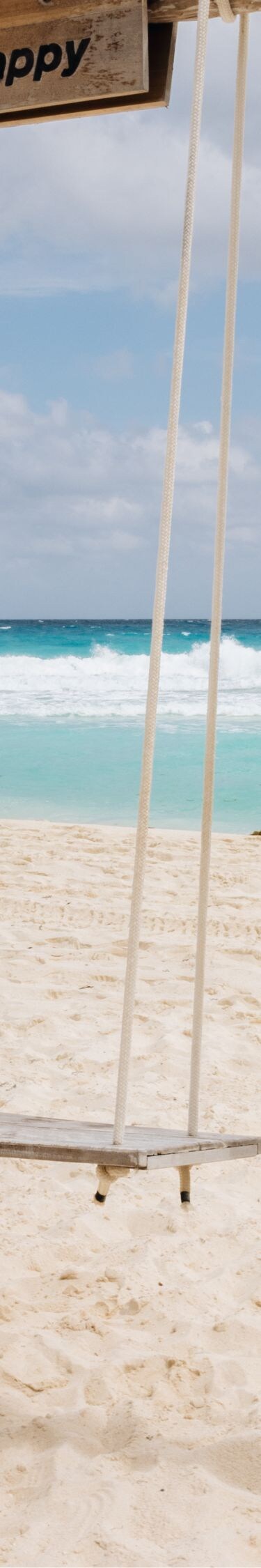 Enjoying a swing on a white-sand beach