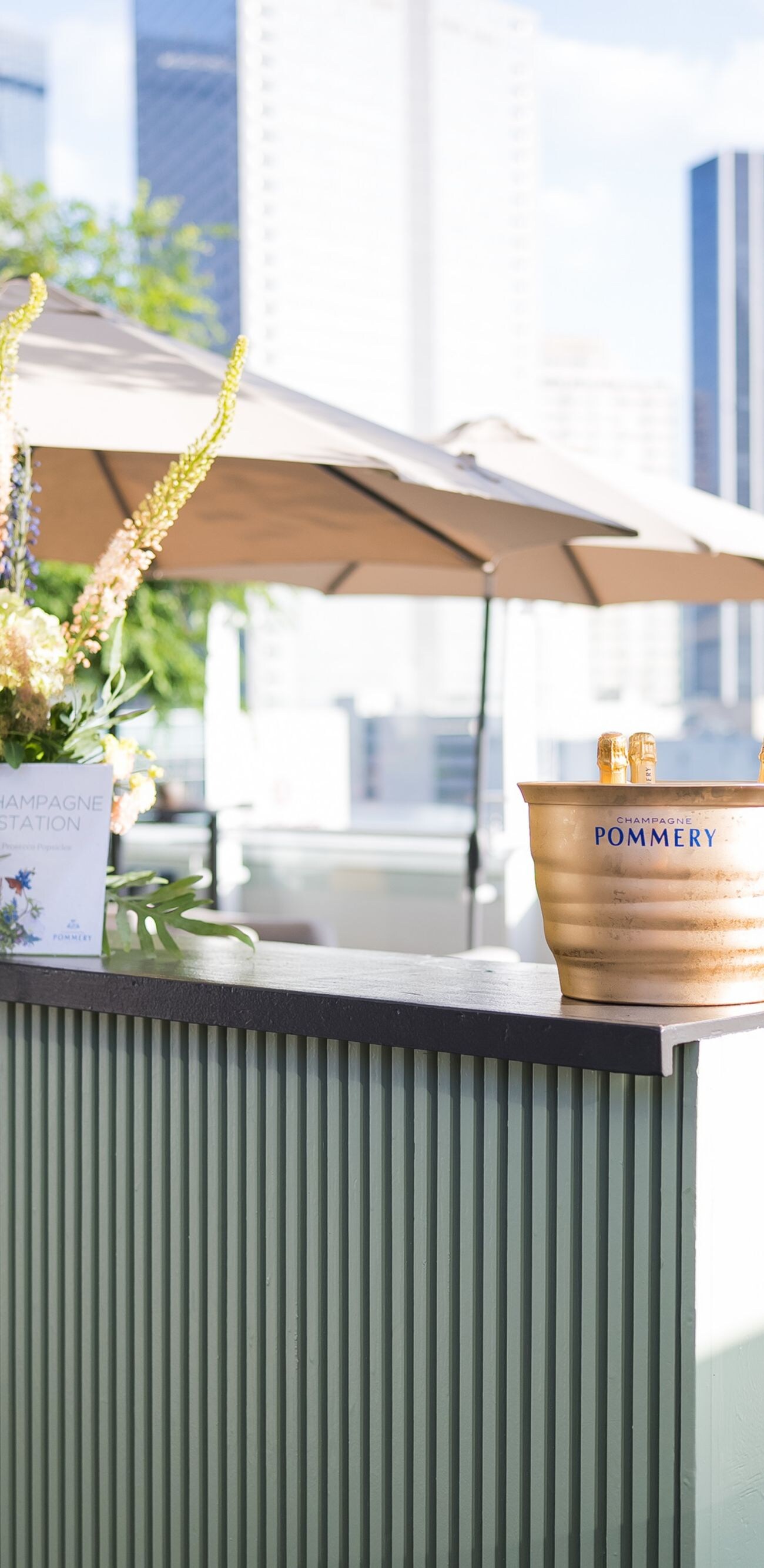 Outdoor terrace bar with flowers and umbrellas