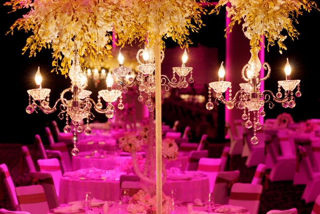 round wedding tables in pink and gold lighting