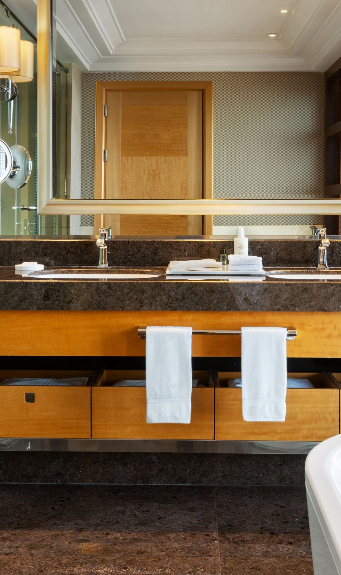 Double sink vanity, large mirror, and white tub