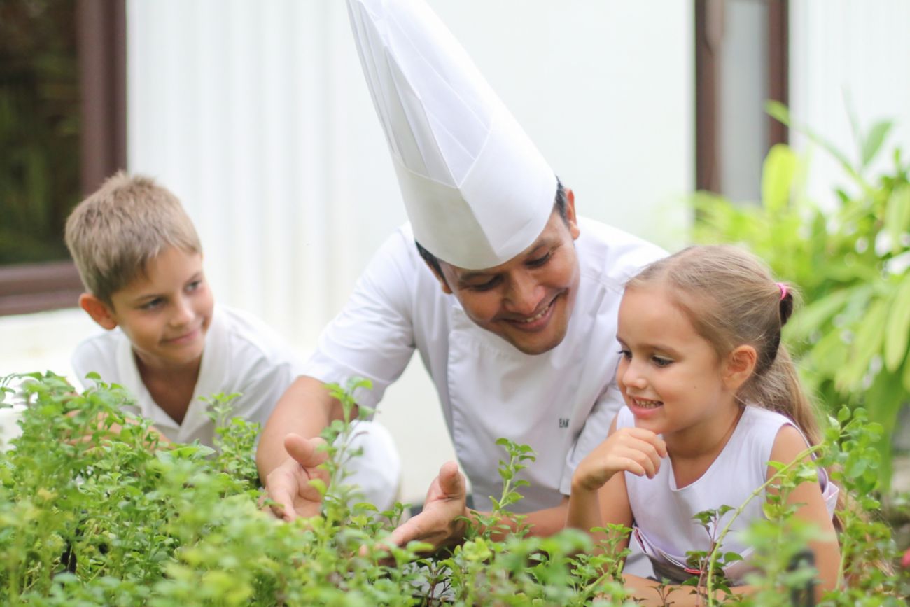 Chef and kids in an herb garden. 