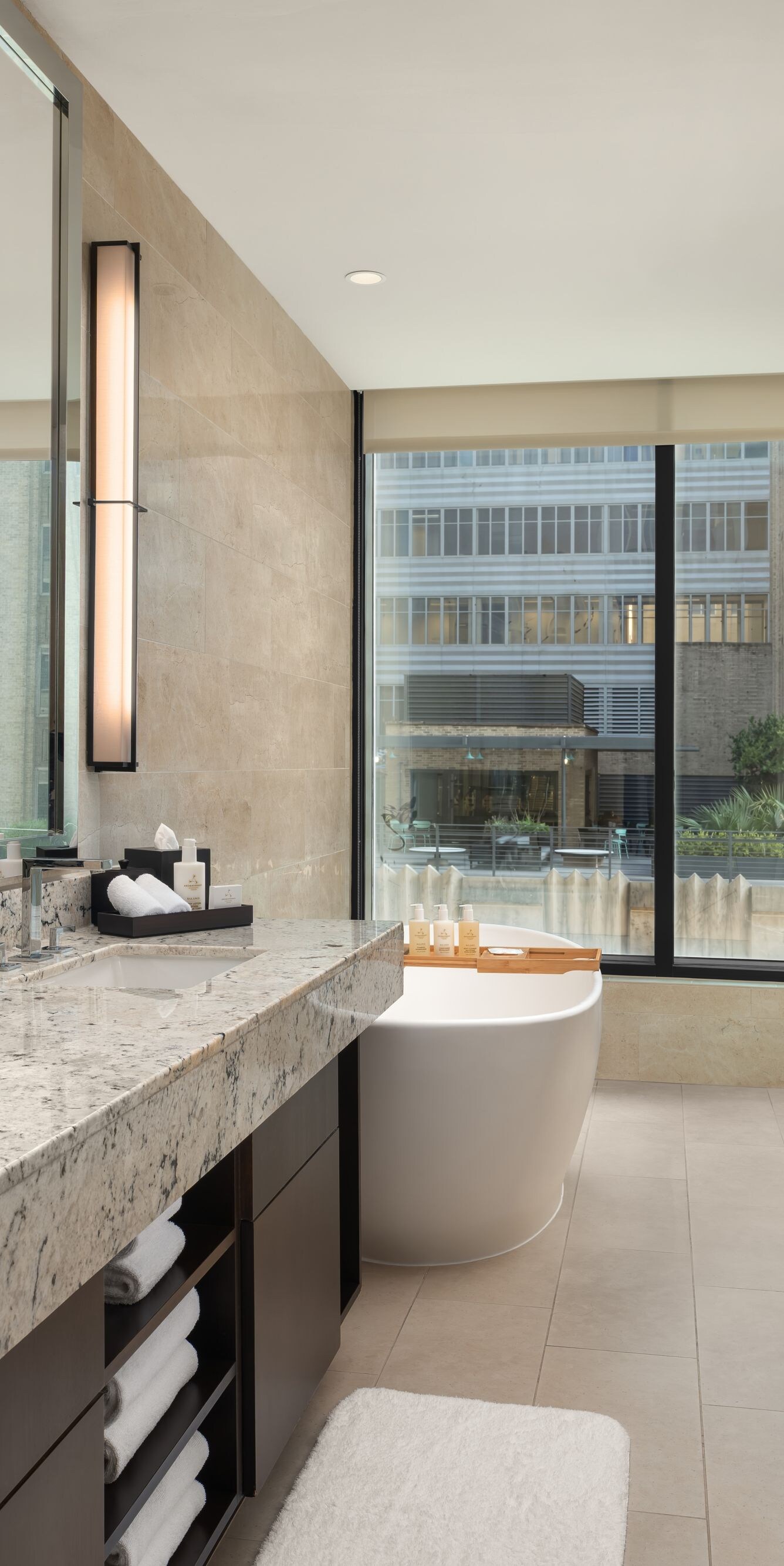 Bathroom with tub and marble surfaces