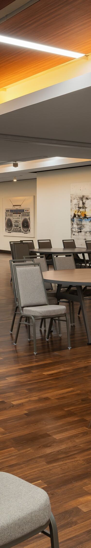 meeting room with round tables and wall art