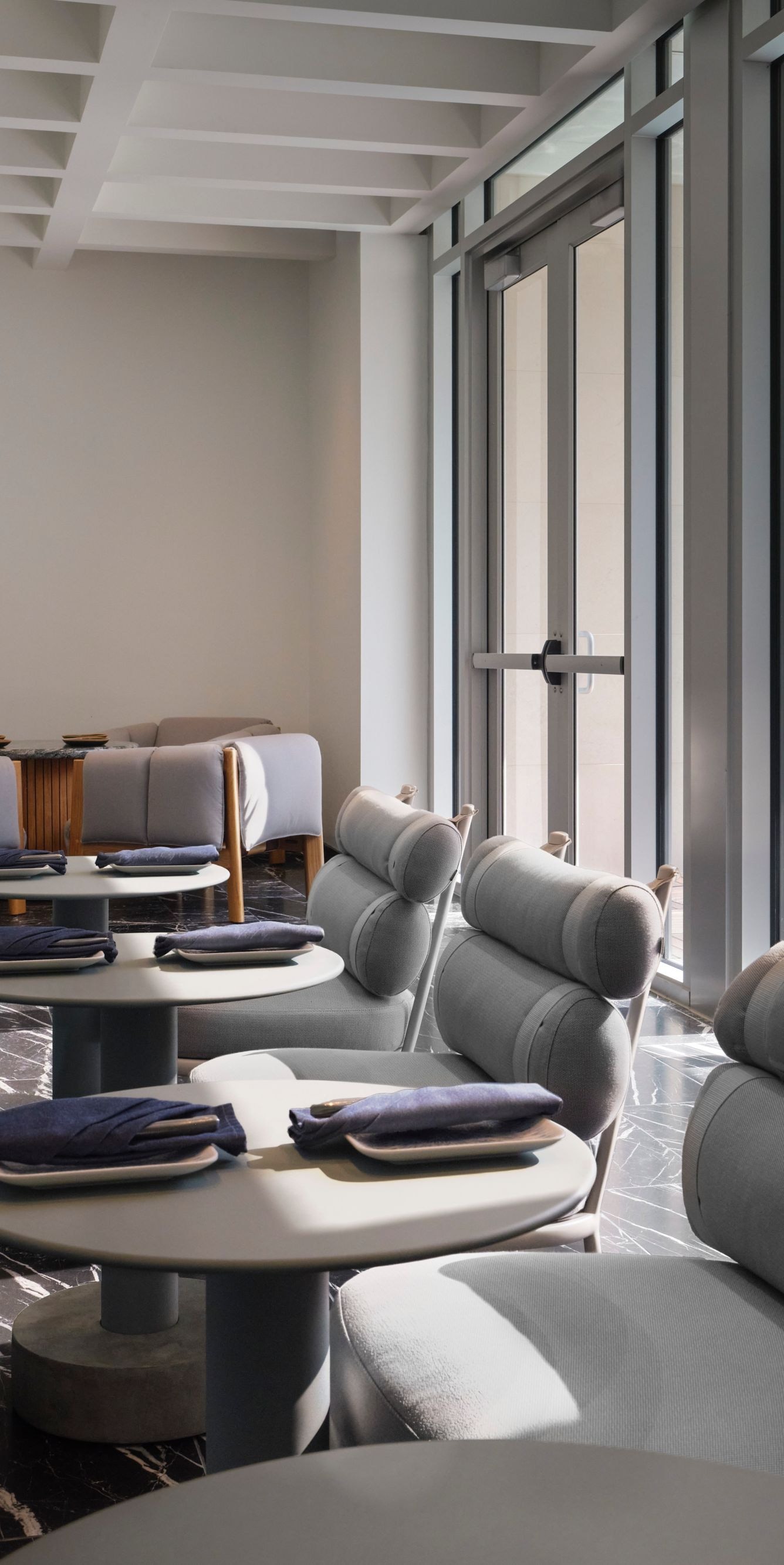 tables and chairs with view of rooftop pool