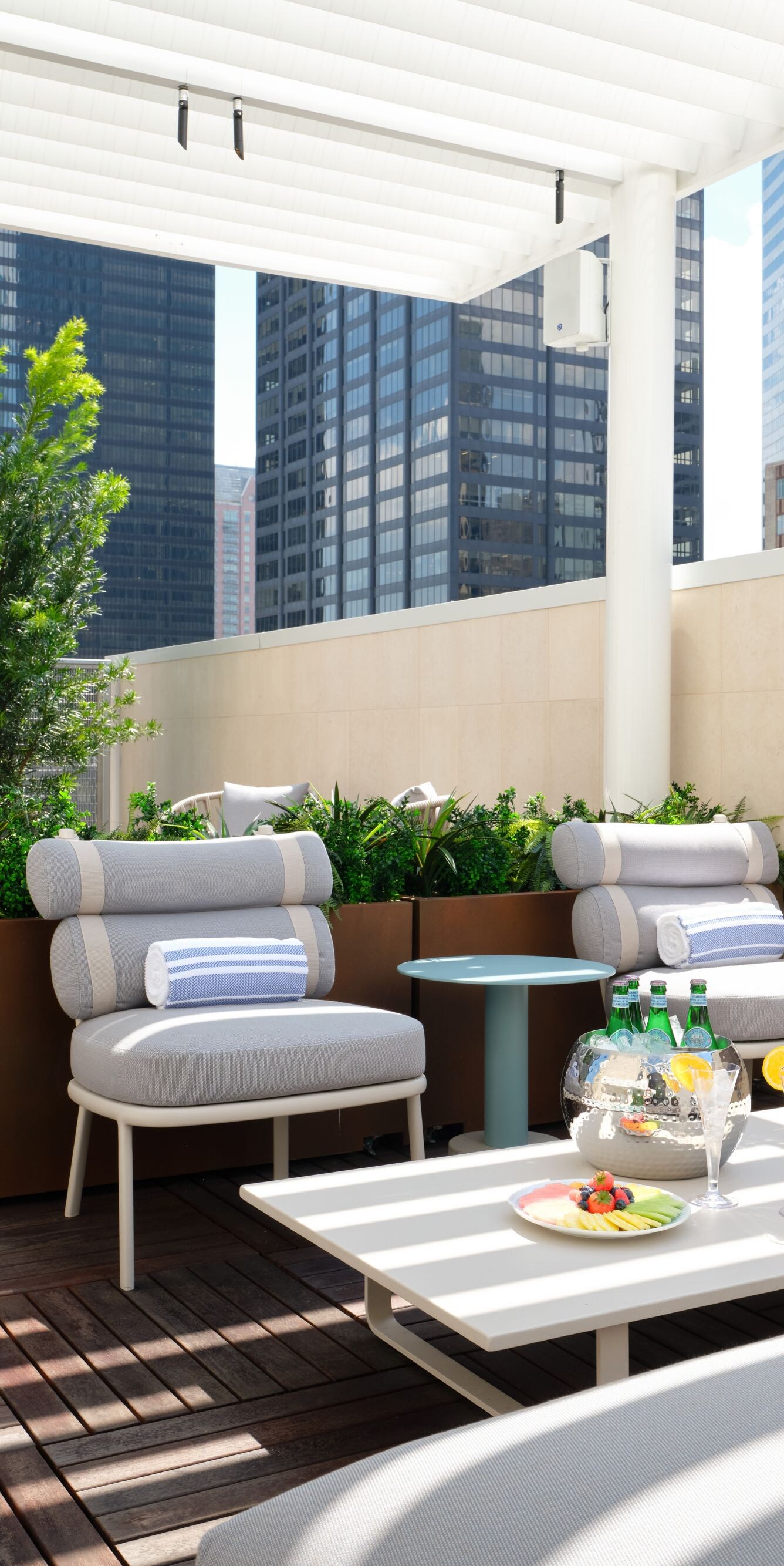 lounge seating under pergola with city views