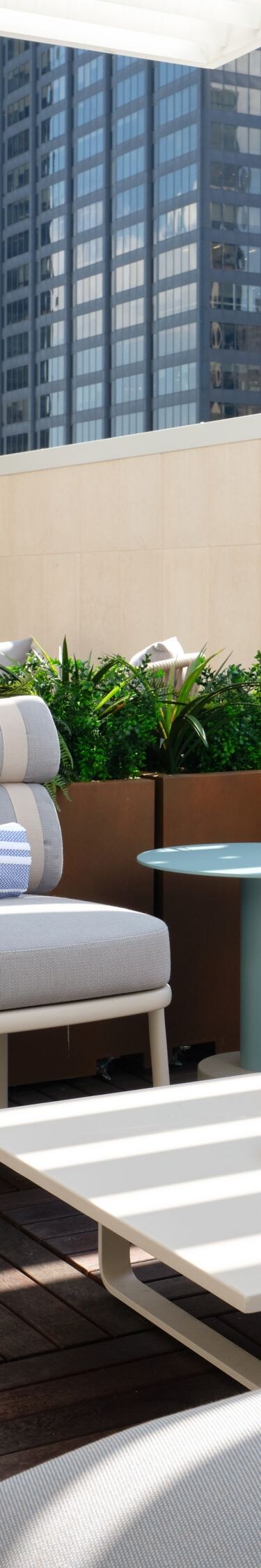 lounge seating under pergola with city views