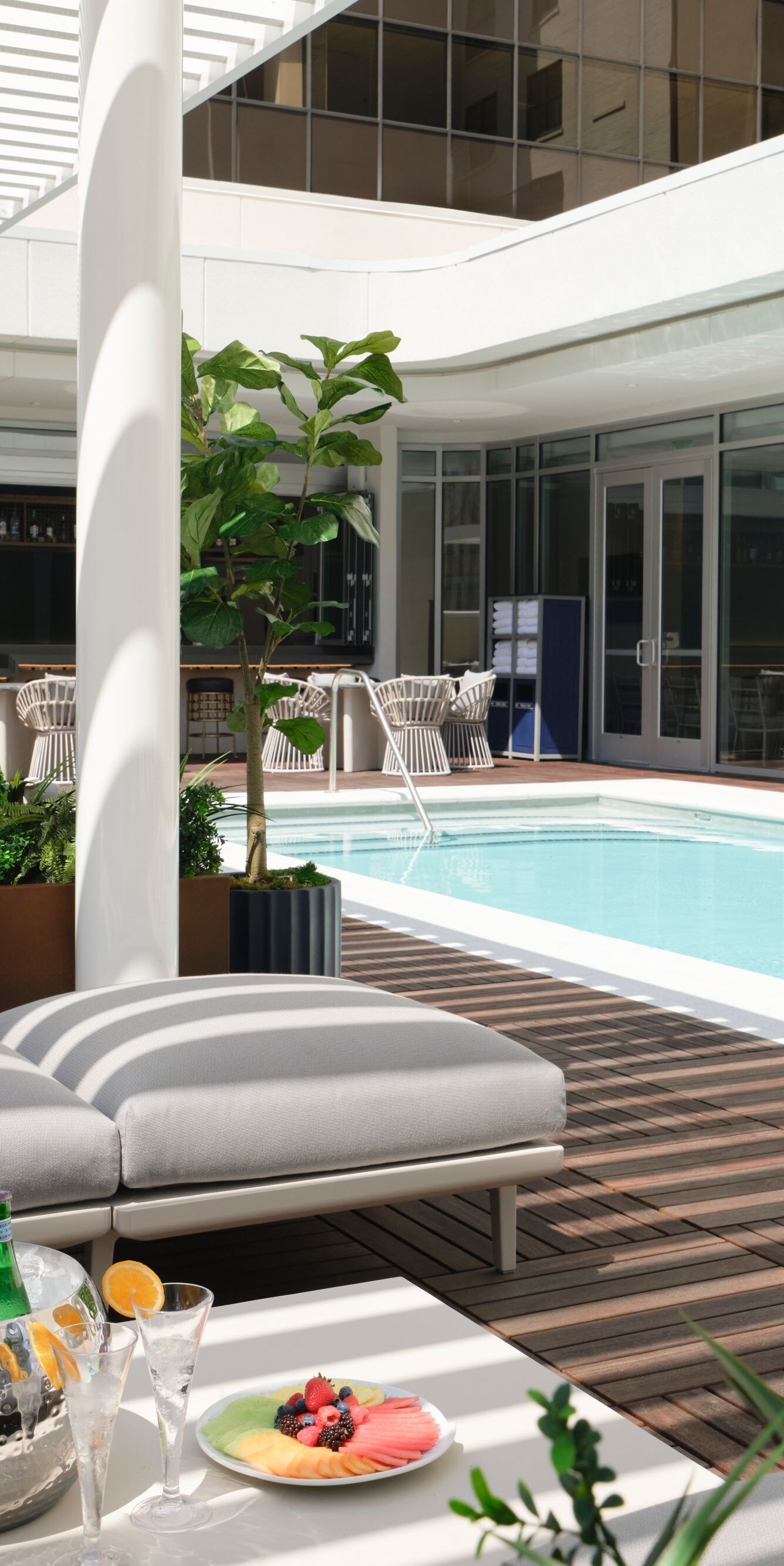 lounge seating under pergola next to pool