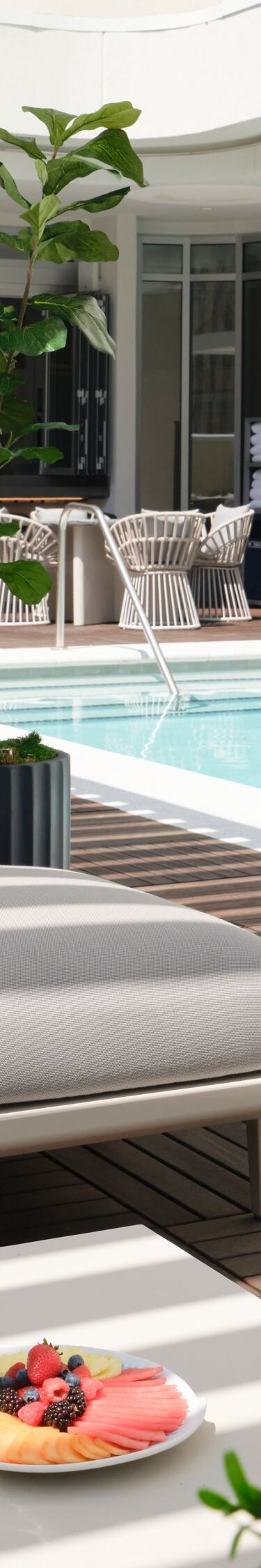 lounge seating under pergola next to pool