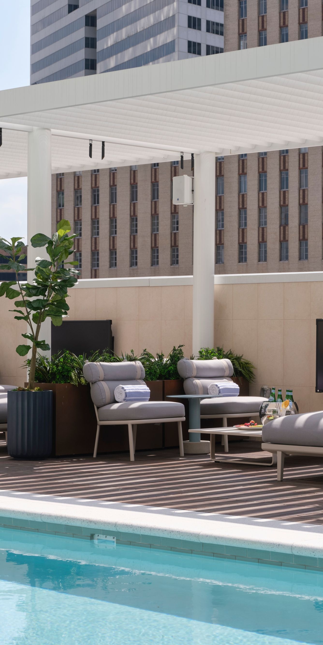 Rooftop pool with lounge chairs and city view