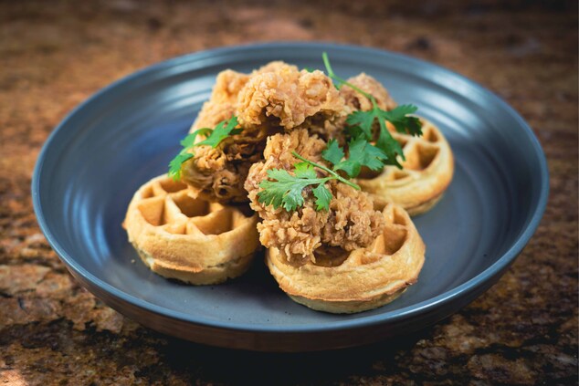 Four mini waffles topped with chicken