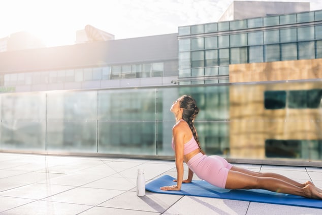 Person doing yoga on a roof. 