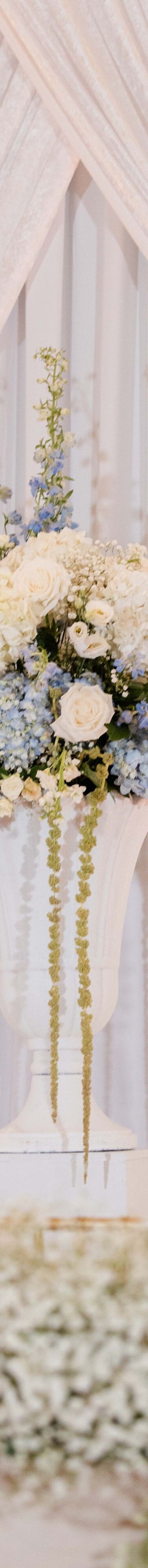 Floral ceremony display beneath drapery