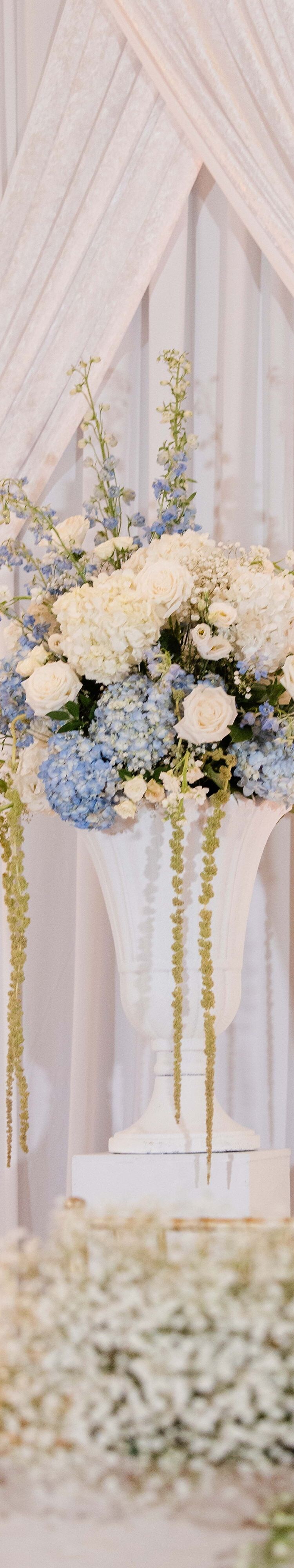 Floral ceremony display beneath drapery