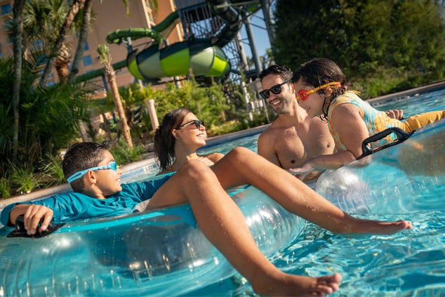 family of four floating down lazy river