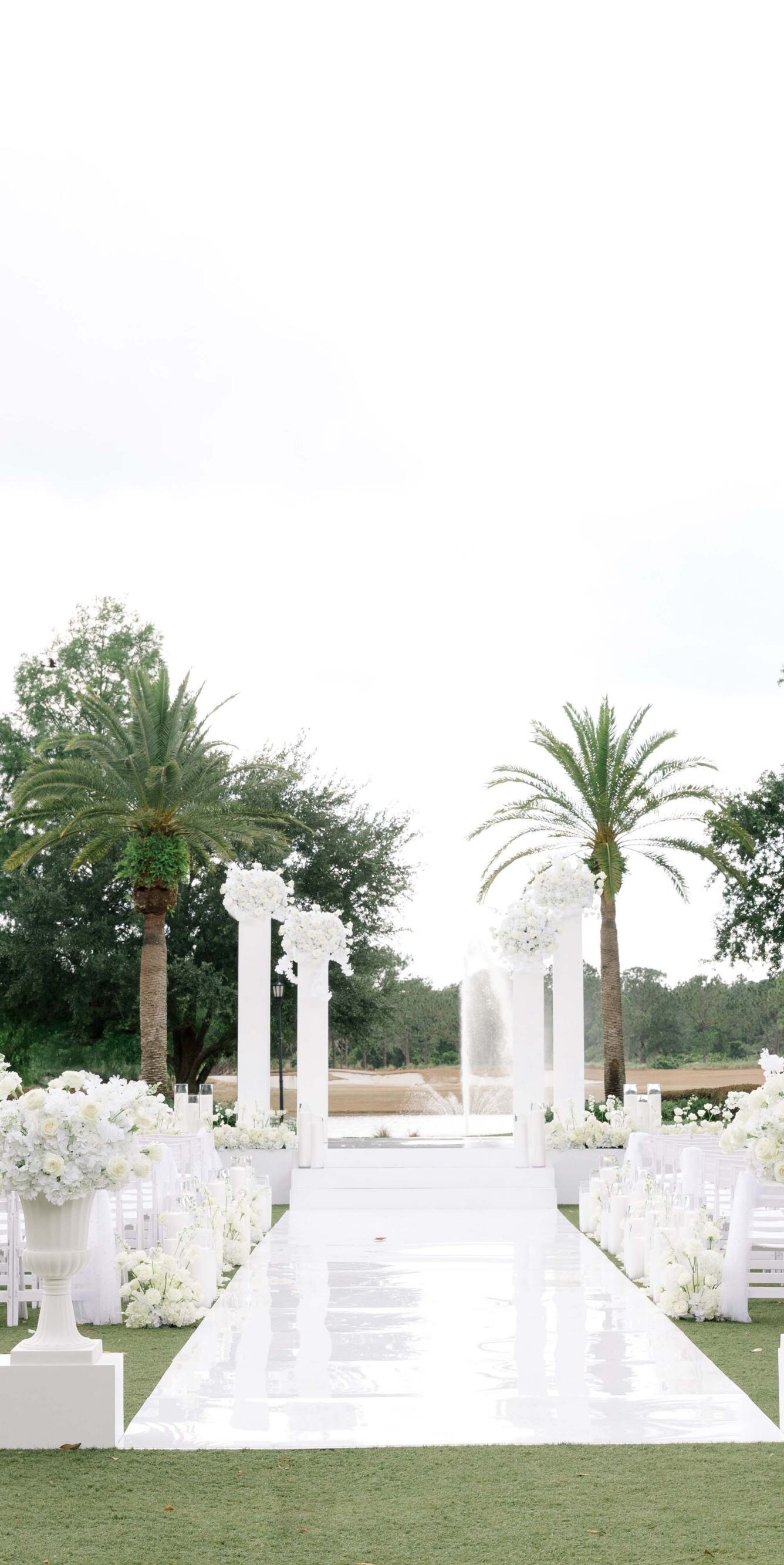 Outdoor ceremony setup with white chairs