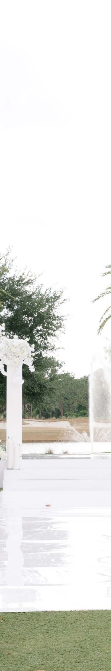 Outdoor ceremony setup with white chairs