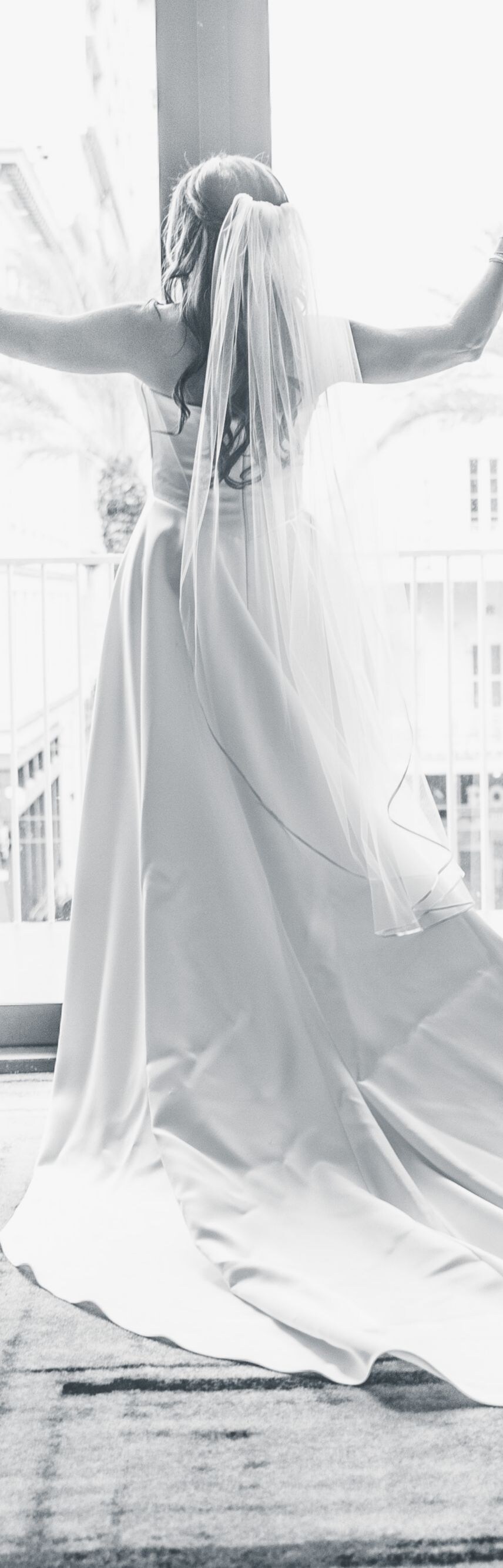 bride by window outside of ballroom