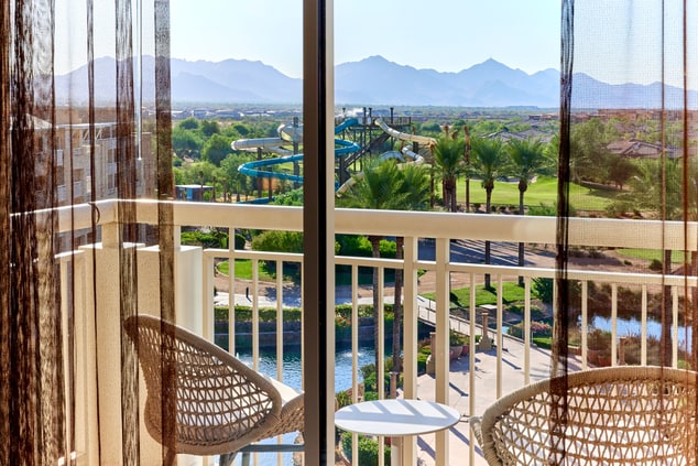 Patio with view of mountains and water slides.