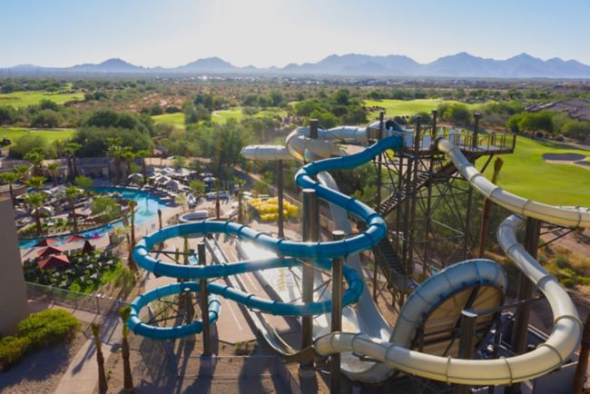Aerial of three waterslides and golf in background