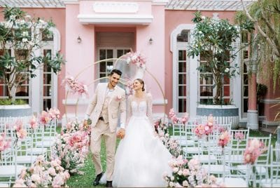 The wedding couple are walking hand in hand